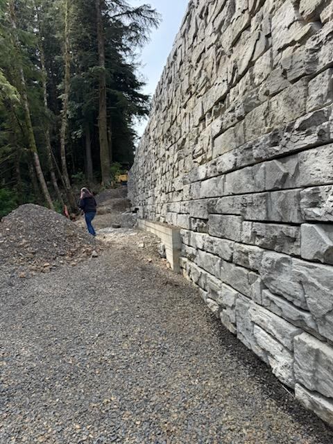Verti-Block wall running along the base of a wooded slope at the Highway 101 repair