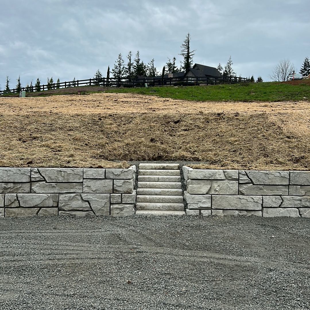 Verti-Block wall with stairs built into the face above a gravel pad
