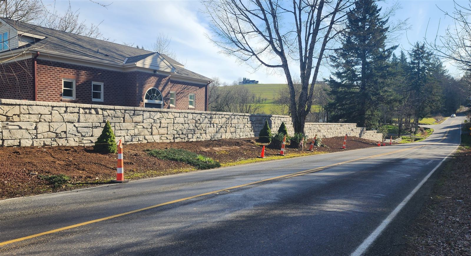 Verti-Block wall running along a road in front of a brick building