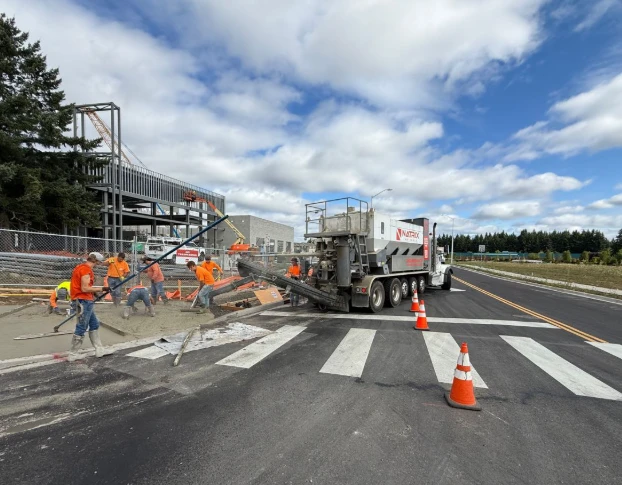 Natrix volumetric truck pouring a crosswalk while the crew finishes the concrete