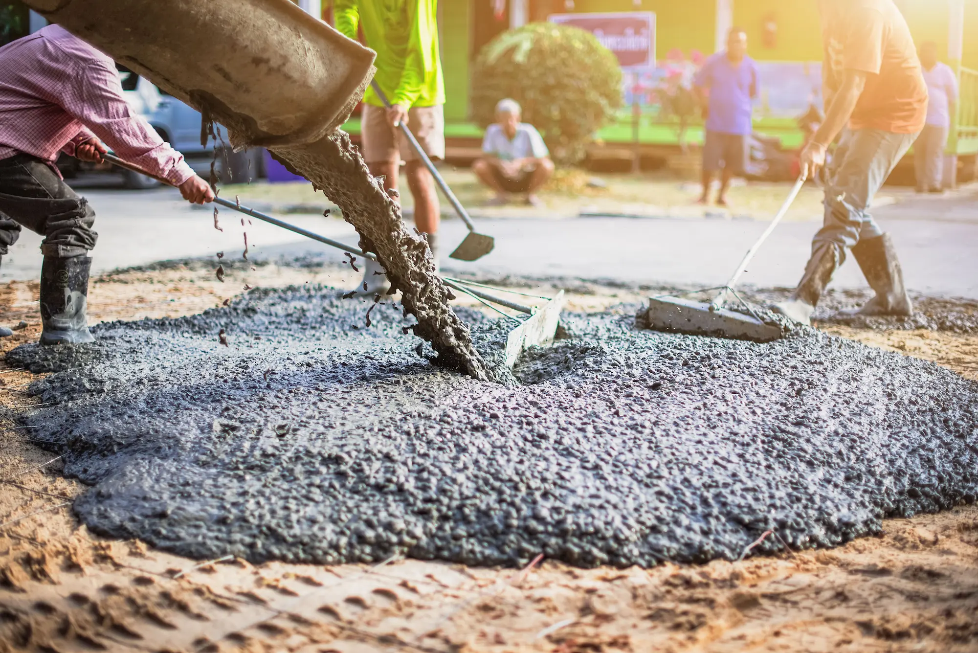 Fresh concrete being placed over rebar