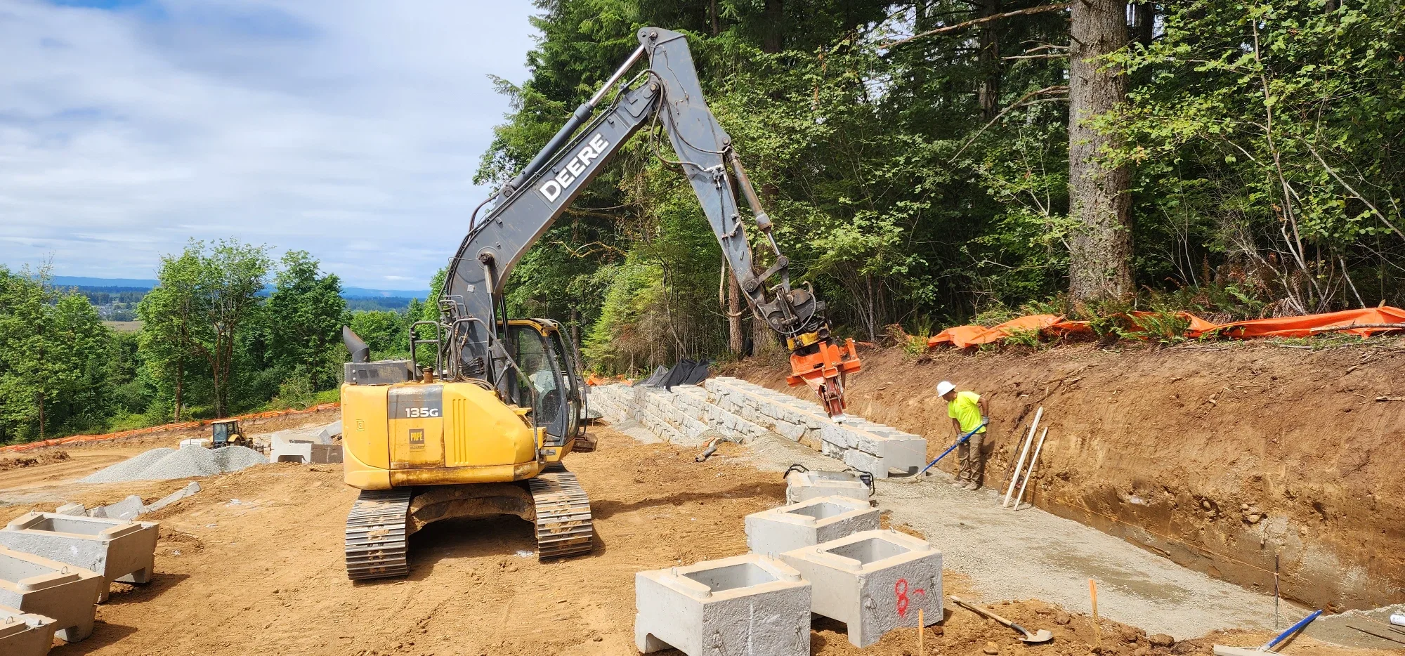 Excavator setting the base course