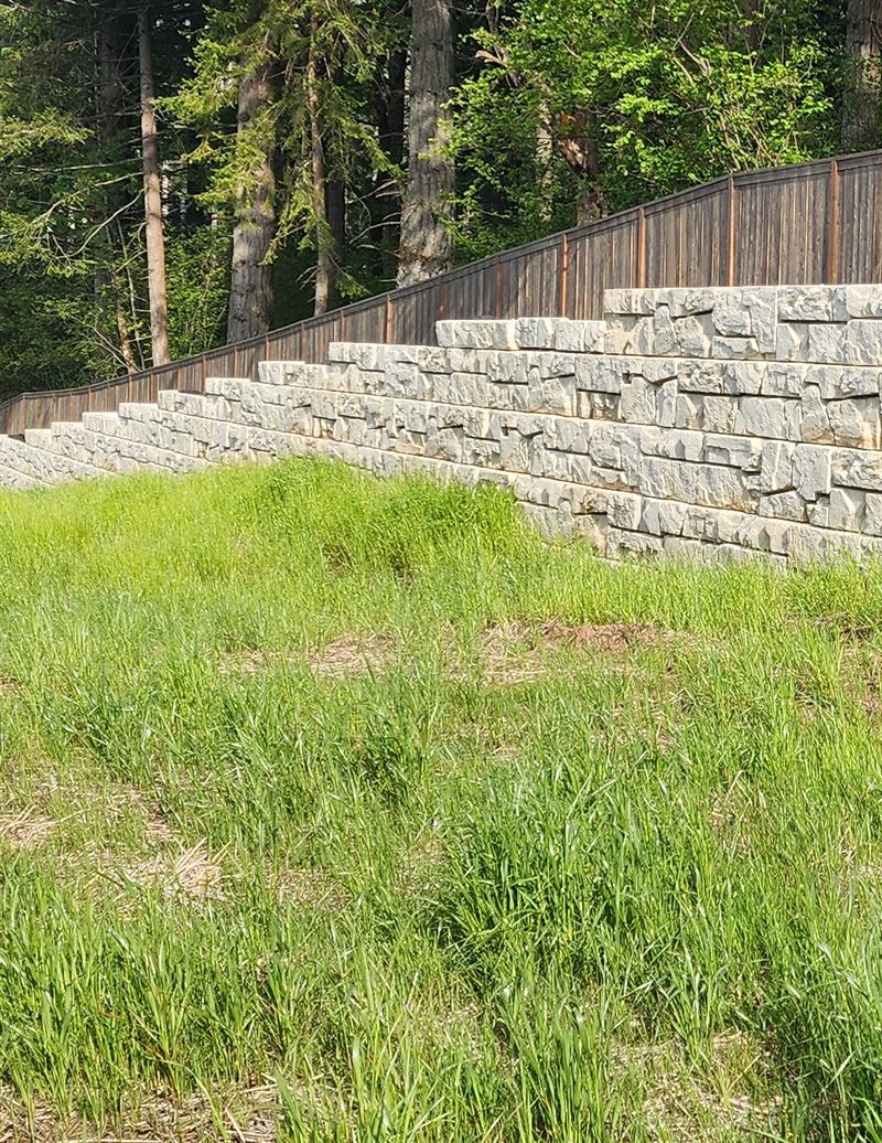 Stepped Verti-Block wall along a fence line