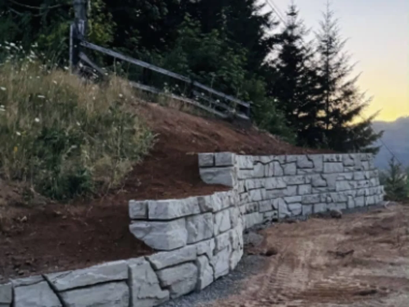 Verti-Block wall stepping up a slope with planting above