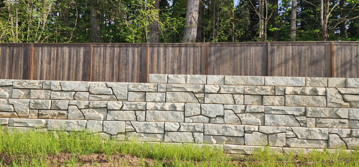 Stepped Verti-Block wall below a cedar fence