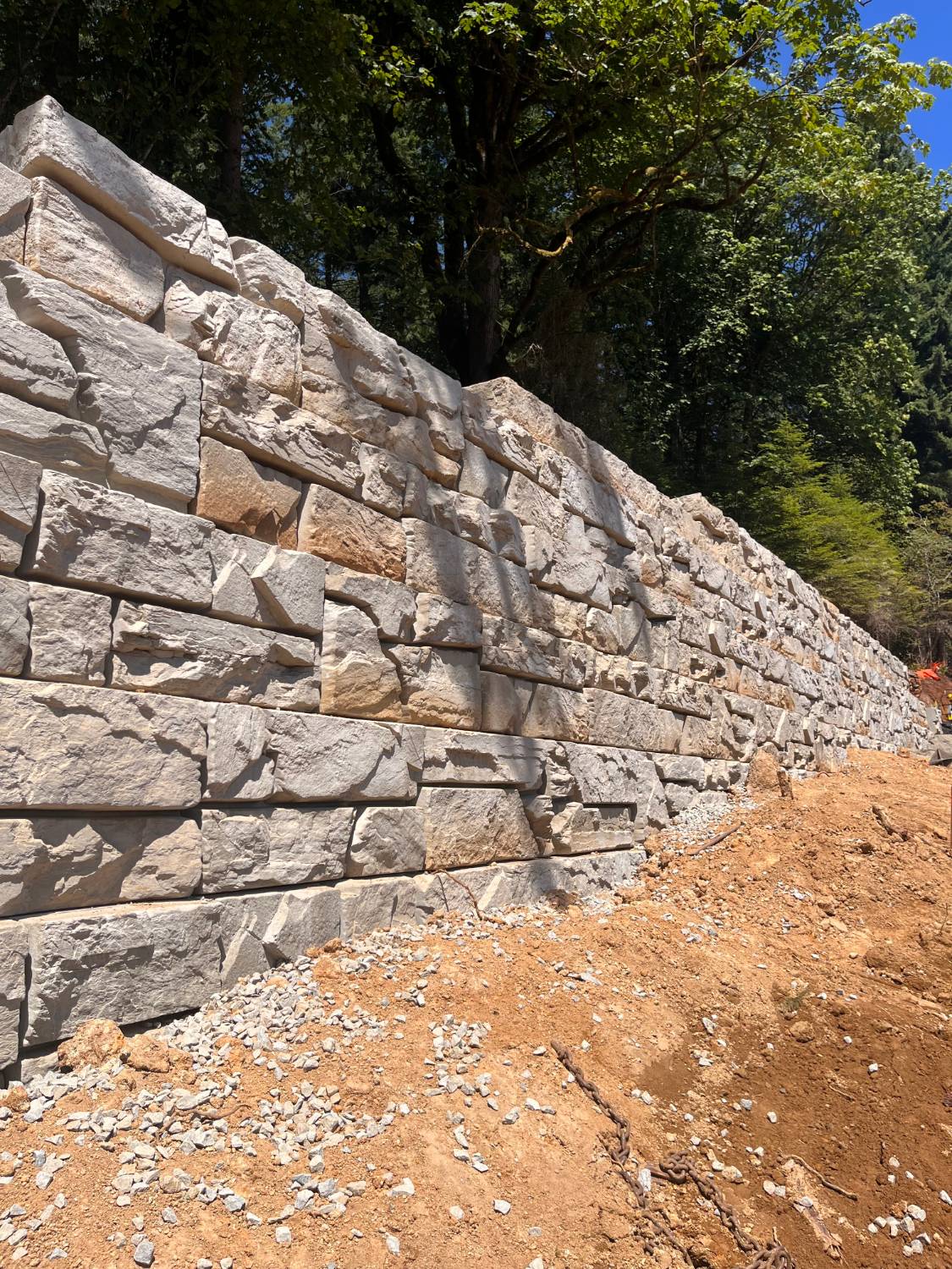 Tall Verti-Block wall under construction in the forest